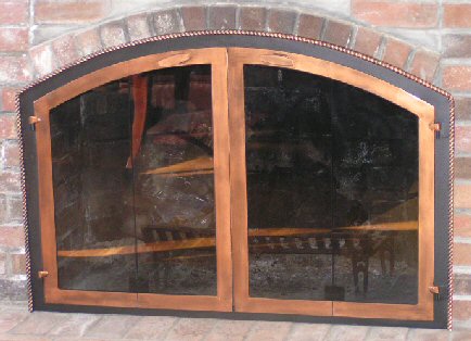 Nantucket arch full fold doors with tight twisted molding black and antique copper