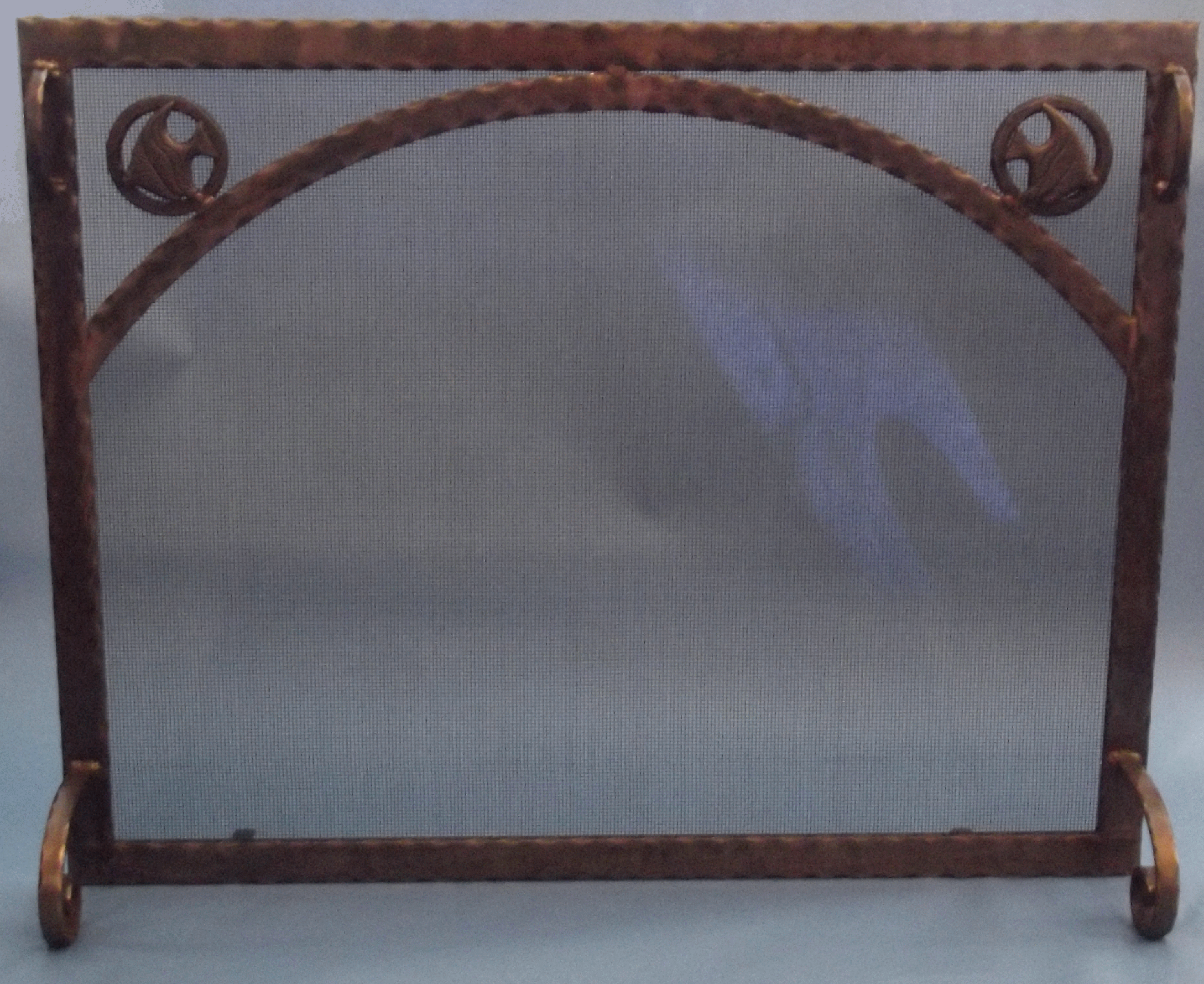 sa 107 flat panel fireplace screen hammered steel, second arch bar, angel fish apps inside hammered steel ring, standard handles and large scroll feet with all antique copper finish